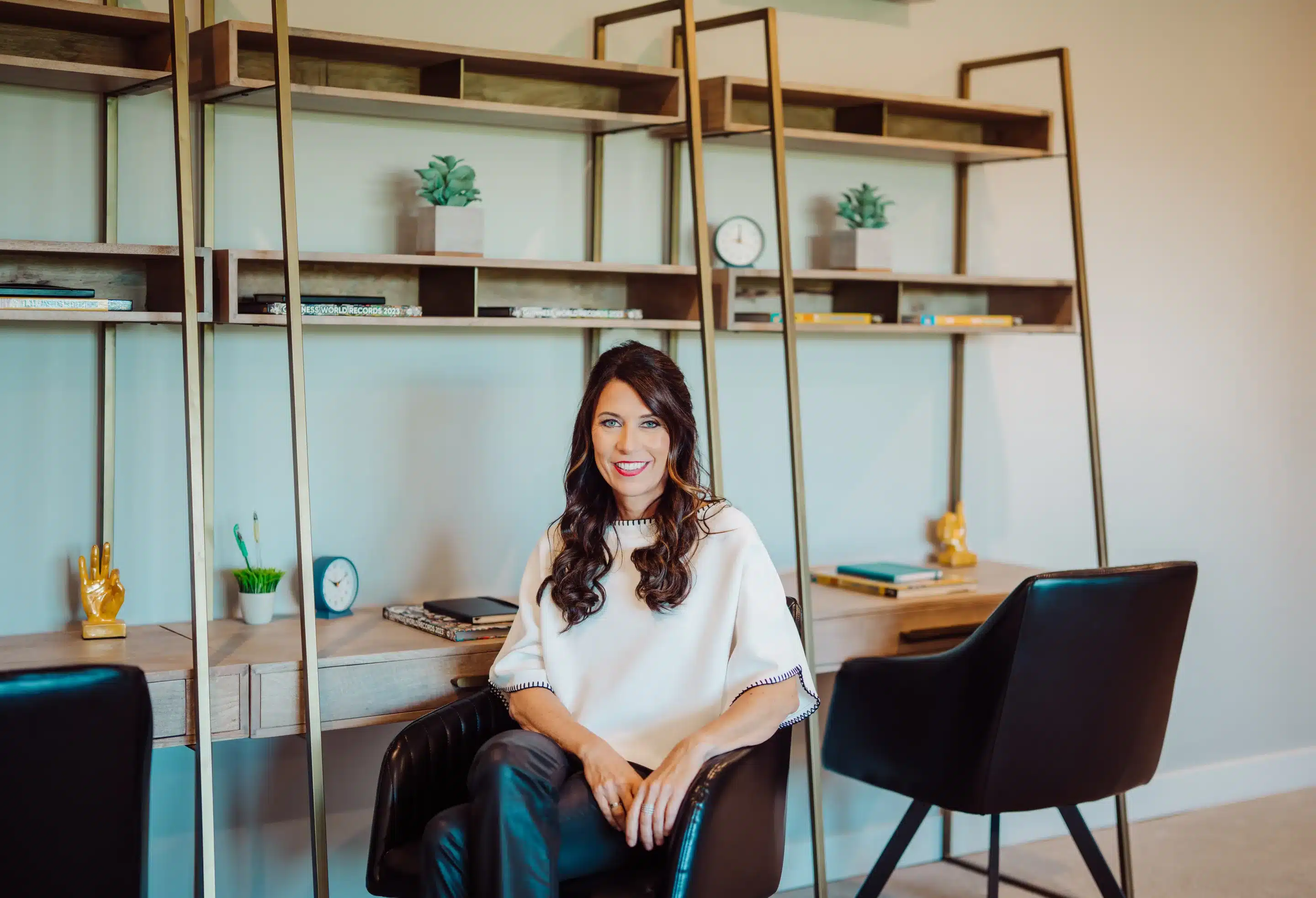 Monika DeRoussel, Cincinnati Realtor, sitting in one of her houses and smiling at the camera